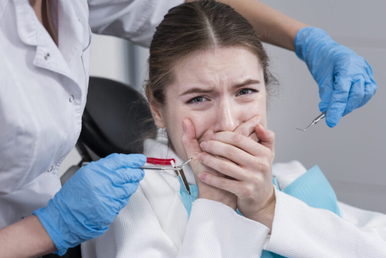 Patient having tartar removed during a professional cleaning