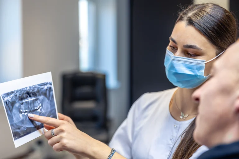 Dentist reviewing a dental X-ray with a patient